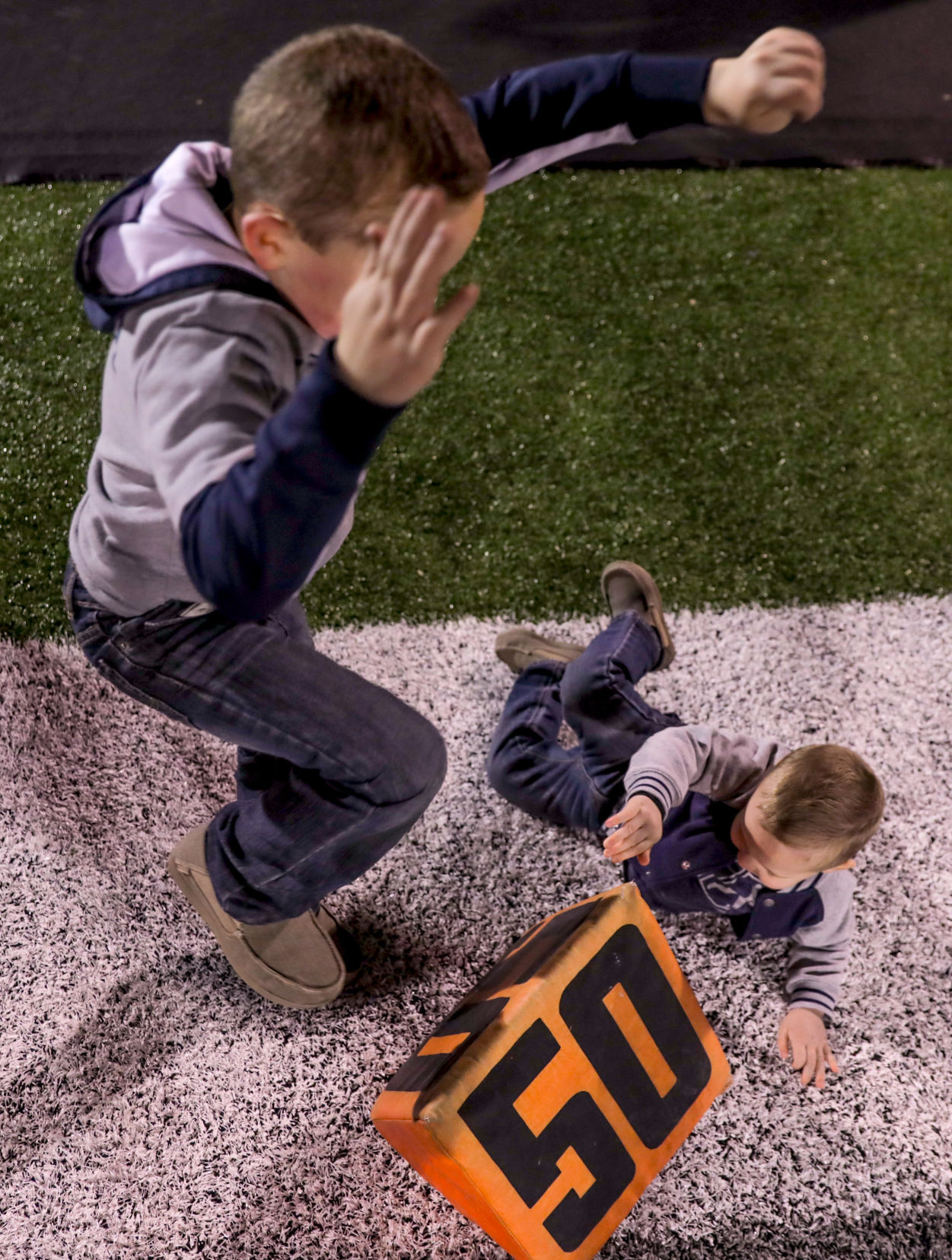 Eston Keller, 6, and Hudson Keller, 2, play with a cushion